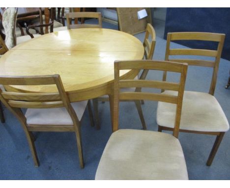 A retro Nathan extending dining table with six matching chairs 