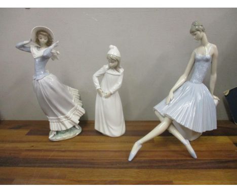 Two Lladro figures, a ballerina sat on a rock, and a woman holding on her hat, and a Nao figure of a girl with a rip in her n