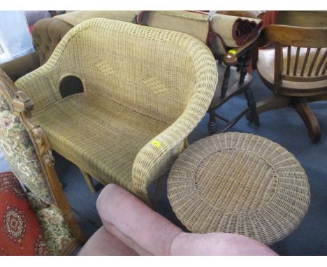 A wicker two seater sofa together with a wicker circular occasional table 