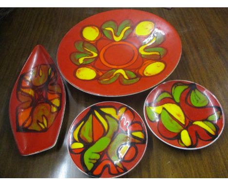 Four Poole pottery Delphis pattern plates to include a large charger 