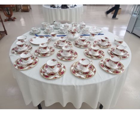 An old Country rose tea service by Royal Albert with 12 plate settings, tea pot, sugar bowl, jug and two sandwich platters