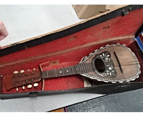 A cased mandolin with mother-of-pearl inlay