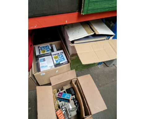 Four boxes of assorted items including books, cine projector and accessories, a box of Sudoko DVD's etc 