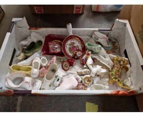 A box of small china items including ceramic shoes and Limoges pottery 