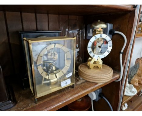 Three clocks, one battery operated, a reproduction Sewills clock under a glass dome and a slate mantle clock with key and pen