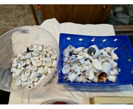 A tub of thimbles and a tub of small ceramic bells 