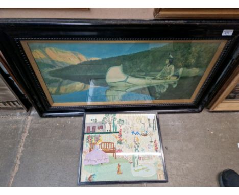 A framed early 20th century print of a Native American in canoe together with a framed needlework picture. 