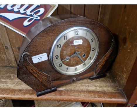 An oak cased mantle clock with key and pendulum 