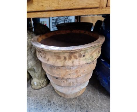 A terracotta planter together with chimney pot cover 
