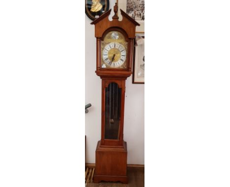 A reproduction long case clock with brass dial, weights and pendulum. 