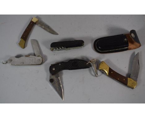 A Collection of Four Penknives and a Swiss Army Type Multitool Knife 