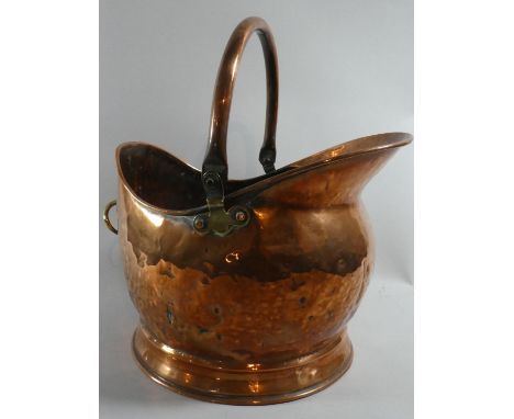 A Copper Helmet Shaped Coal Scuttle, 37cm high 