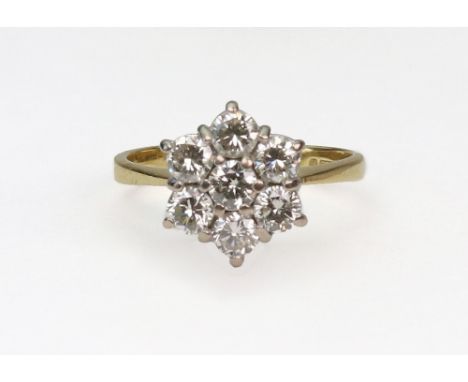 A modern 18ct gold and diamond seven stone cluster ring, the round brilliants approx. 1.00cts total, claw set in white to a y