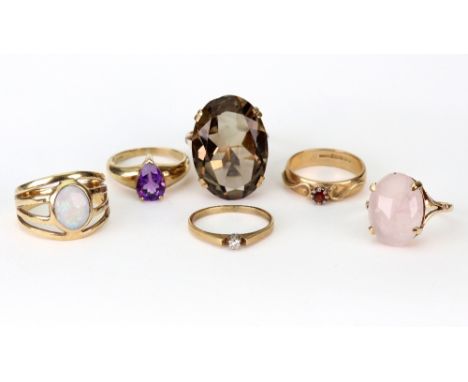 Six 9ct gold and gem set rings, comprising a cabochon rose quartz single stone ring, Birmingham 1990; a large oval smoky quar