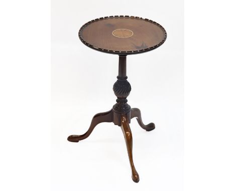 An Edwardian mahogany and fan inlaid wine table, 27.5cm diameter, a similar period mahogany cake stand and a pair of rush sea