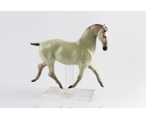 Christine Suzman (South African, b.1945) Trotting Horse signed with initials ceramic on perspex stand 23cm high, 24cm across.