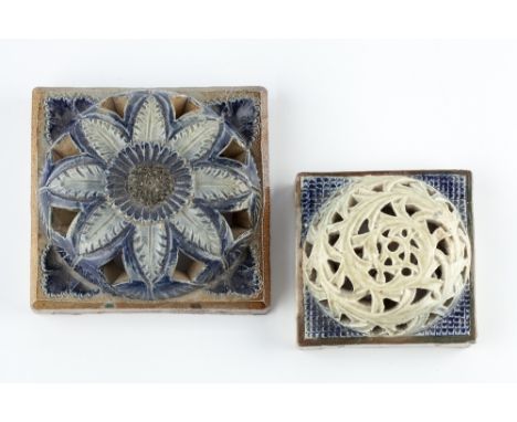Robert Wallace Martin (British, 1843-1923) for Martin Brothers Two domed pierced tiles the larger with flowerhead motif in bl