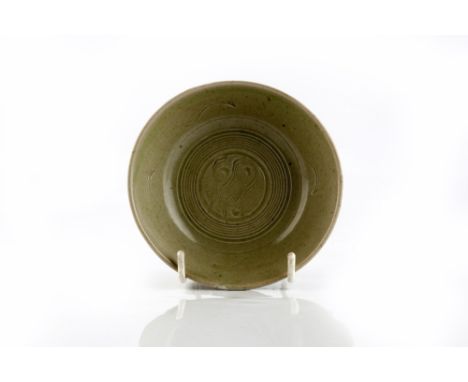 Bernard Leach (British, 1887-1979) Dish incised wave decoration, celadon glaze impressed potter's seal 11.3cm diameter.