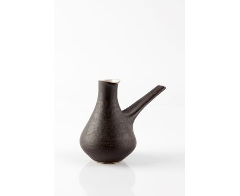 Lucie Rie (1902-1995) Pouring vessel matt black glaze impressed potter's seal 15.3cm high, 17cm across. Provenance: Kenneth M