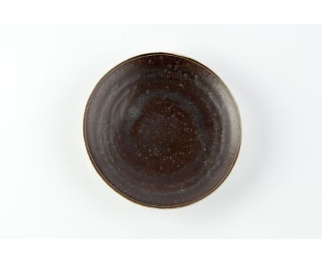 Lucie Rie (1902-1995) Dish matt black glaze, incised rim impressed potter's seal 13.8cm diameter.