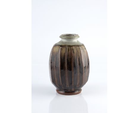 Mike Dodd (British, b.1943) Vase ash and tenmoku glaze and facetted sides impressed potter's seal 21cm high.