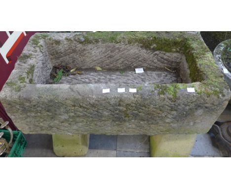 A rectangular concrete planter on pedestal stand 