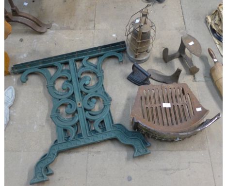 A large mixed lot of metalware including wrought iron table ends, cast iron fire grate and fender, a paraffin lamp, two cast 