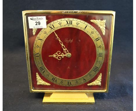 Imhof eight day Swiss mantel clock of square form on a gilt base, having gilt foliate mounts. Height 23cm approx x 20cm wide 
