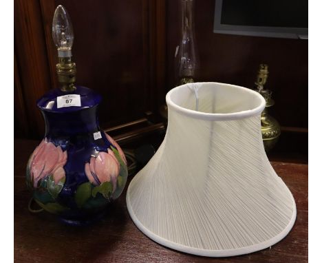 Moorcroft art pottery tube lined lily decorated dark blue ground baluster lamp base with shade. 26cm high approx (just base).