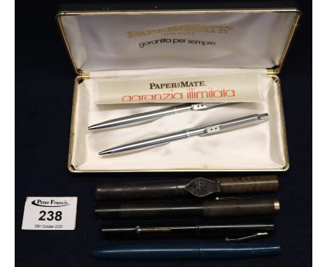 A Papermate stainless steel pen and pencil set in original box, together with a leather case containing a group of vintage wr