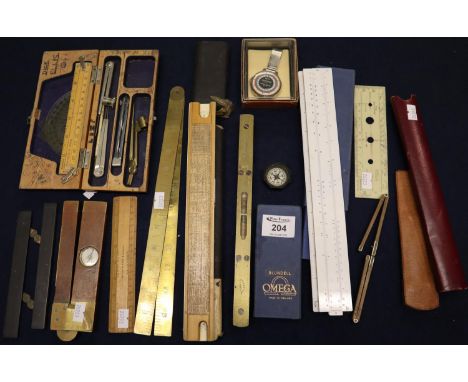 Box of assorted slide rules, general rulers, spirit level, artisans wooden folding ruler with compass and brass mounts, drawi