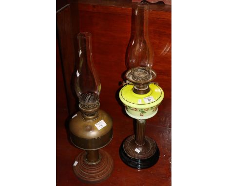 Brass double burner oil lamp with ceramic reservoir, brass pedestal on ceramic foot, together with another all brass double b