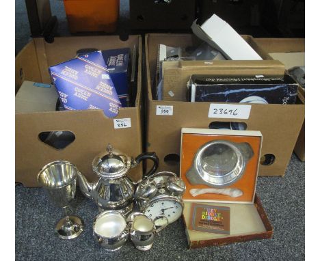 Two boxes of assorted metalware and other items to include; placemats, teaware, goblets, alarm clock etc. (B.P. 21% + VAT) 