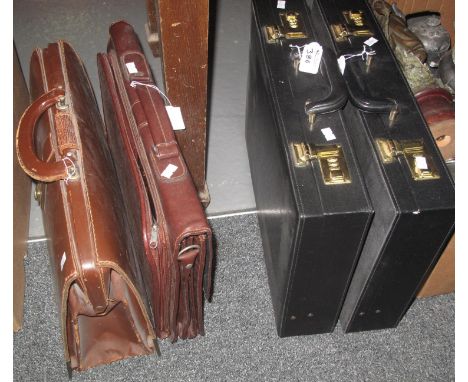 Two brown vintage briefcases, together with two other modern briefcases. (B.P. 21% + VAT) 