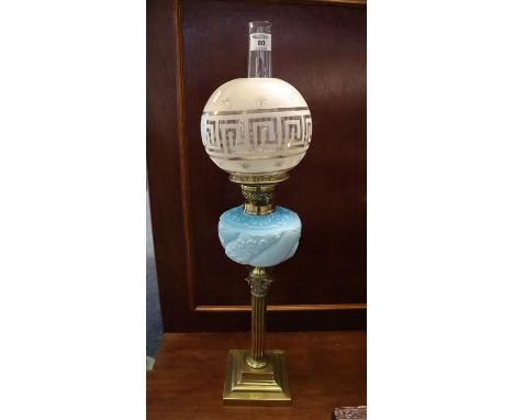 Late Victorian brass double burner oil lamp with coloured glass repousse wrythen reservoir on brass corinthian column stepped