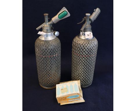 Two similar vintage soda syphons with metal wicker finish mounts and a box of Sparklets bulbs. (B.P. 21% + VAT) Used vintage 
