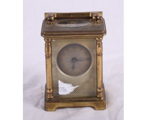 A French carriage clock with engine turned silvered face in brass case