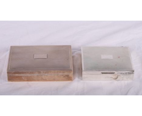 A silver cigarette box with engine turned lid and a smaller similar