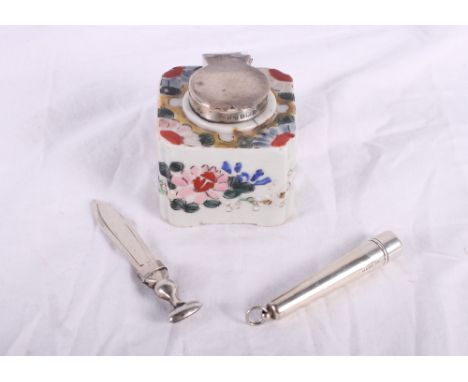 A silver mounted cheroot holder in silver case, a ceramic inkwell with silver lid and a silver bookmark in the form of a dirk