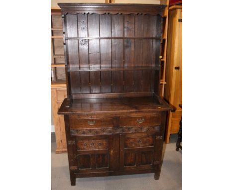 A 17th Century design oak dresser with two shelf boarded back, base fitted two drawers and cupboards, 42" wide