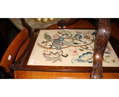 A mahogany framed firescreen, glazed panel inset tapestry of a hawk perched on a snowy branch, and another firescreen (damage