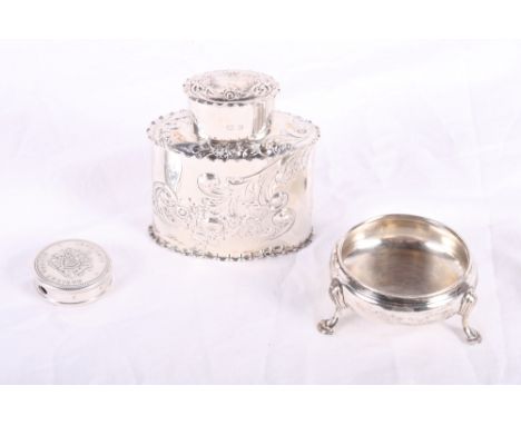 An embossed silver tea caddy, a silver cauldron salt and a silver sweetener dispenser