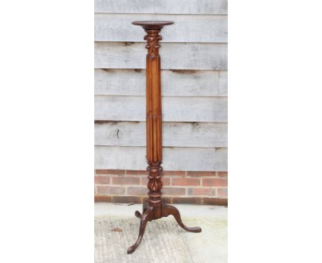 A 19th Century mahogany torchere with reeded and fluted stem and tripod base
