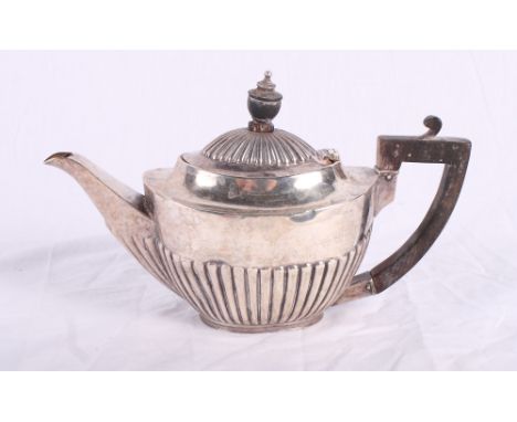 A bachelor's silver teapot with half reeded decoration and ebonised handle, 7.2oz troy approx