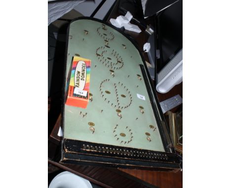 An ebonised bagatelle board and a boxed set of Chad Valley Rainbow dominoes