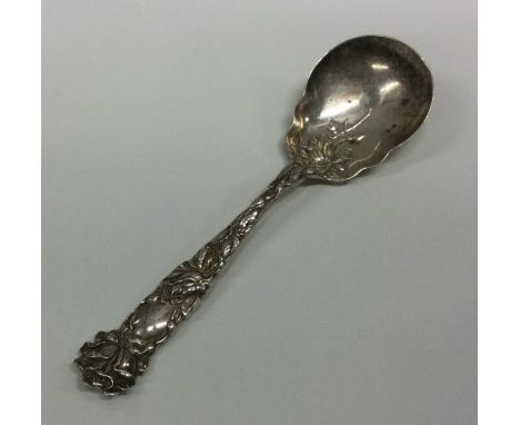 A large chased silver caddy spoon together with a patent. Marked Sterling. Approx. 37 grams. Est. £30 - £50.