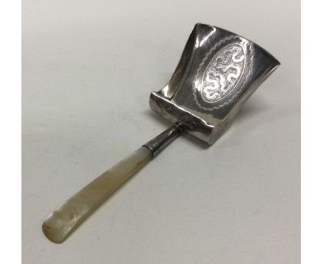 A large George III fine silver and MOP bright cut caddy spoon. Birmingham 1809. By William Boot. Approx. 9 grams. Est. £60 - 
