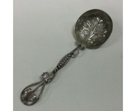 A silver cast Victorian caddy spoon of leaf form with grape decoration. Birmingham 1859. By Hilliard and Thompson. Approx. 22