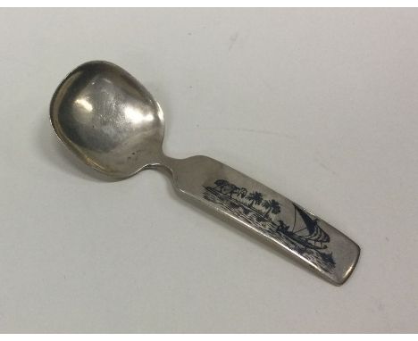 A Persian silver and enamelled caddy spoon depicting a river scene. Approx. 25 grams. Est. £30 - £50.