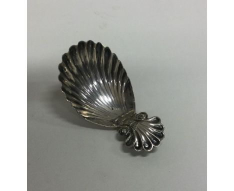 A George III silver caddy spoon with shell terminal. London 1825. Approx. 12 grams. Est. £30 - £50.